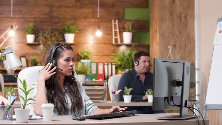 support customer woman wearing headphones talking 2021 12 11 00 32 22 utc - The High Cost of Waiting: Real-world Impacts of Slow Support Responses - Troubleshooting
